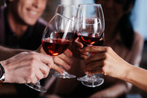 four people toasting with glasses of Lamborghini red wine