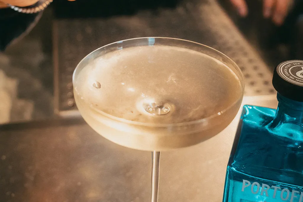 Elegant cocktail in a coupe glass perfect for winter drinks with Portofino Dry Gin.