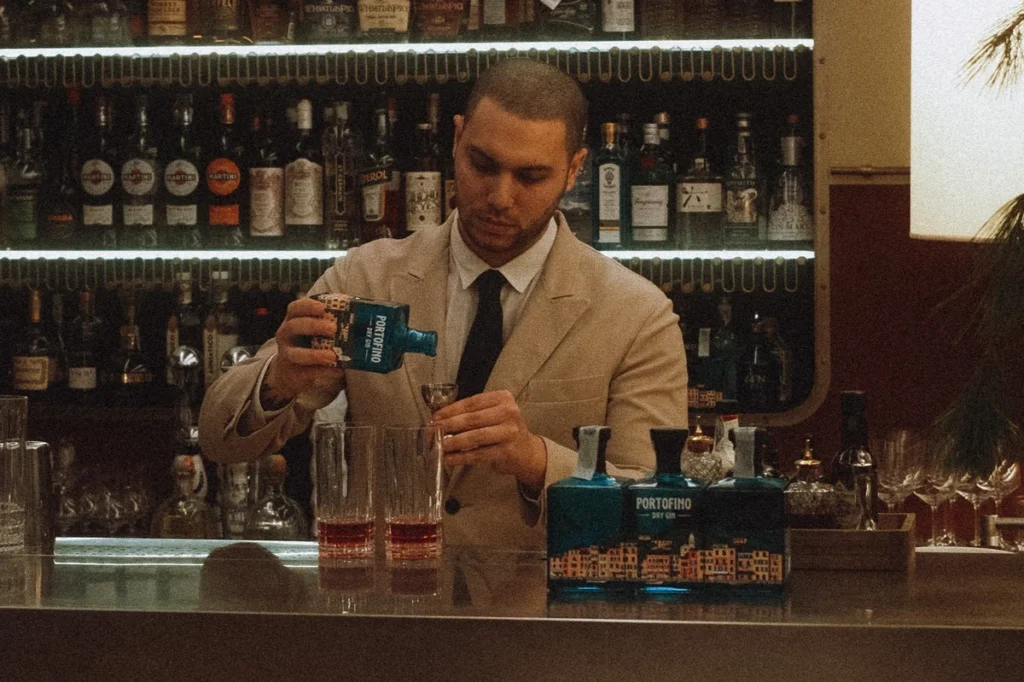 Bartender preparing winter drinks with Portofino Dry Gin in an elegant bar.