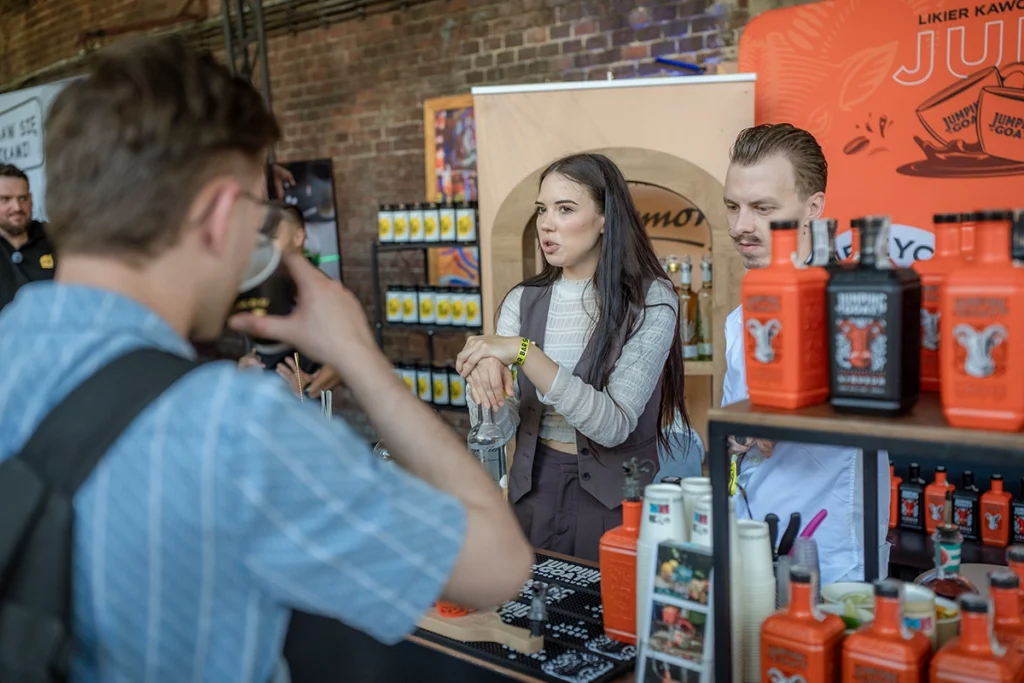 Jumping Goat representative talking with a visitor at the Crimston Spirits tasting stand during Better Bar Show 2026 in Krakow.