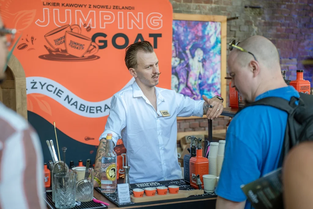 Jumping Goat representative at the coffee liqueur tasting stand during Better Bar Show 2026 in Krakow, Poland.